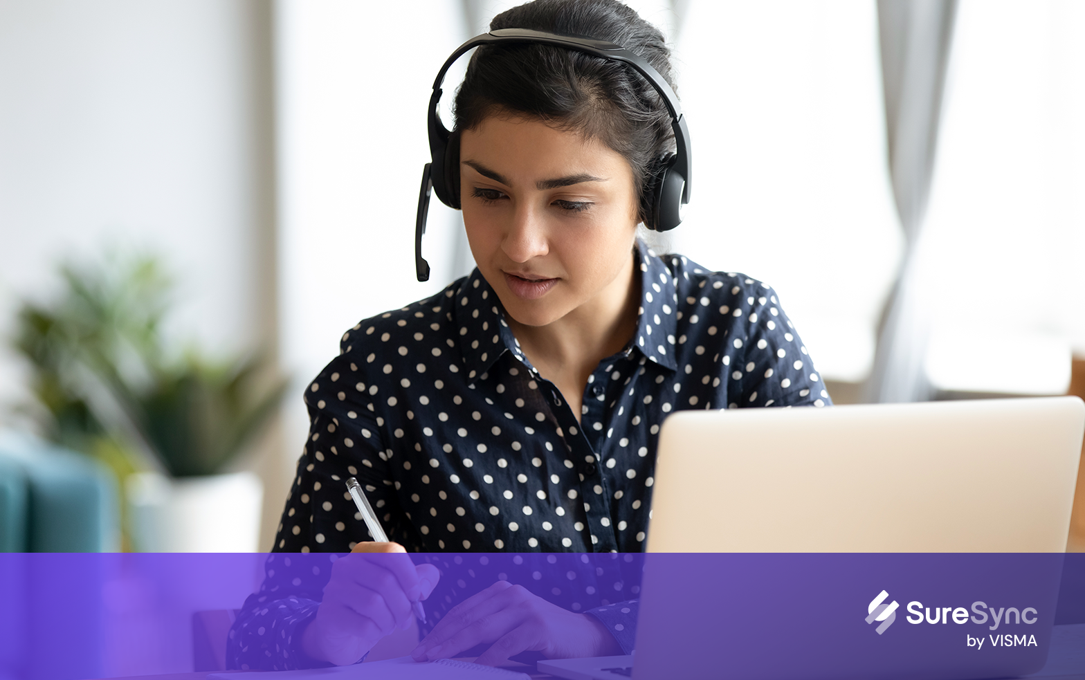 Portrait of a young business woman sitting behind laptop and working
