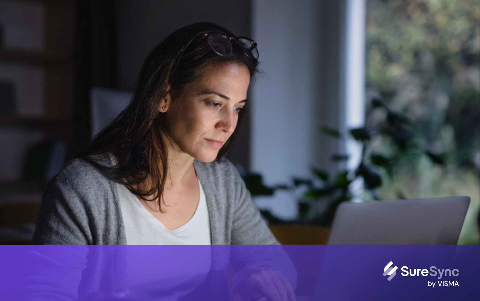 Worried looking woman looking at a laptop
