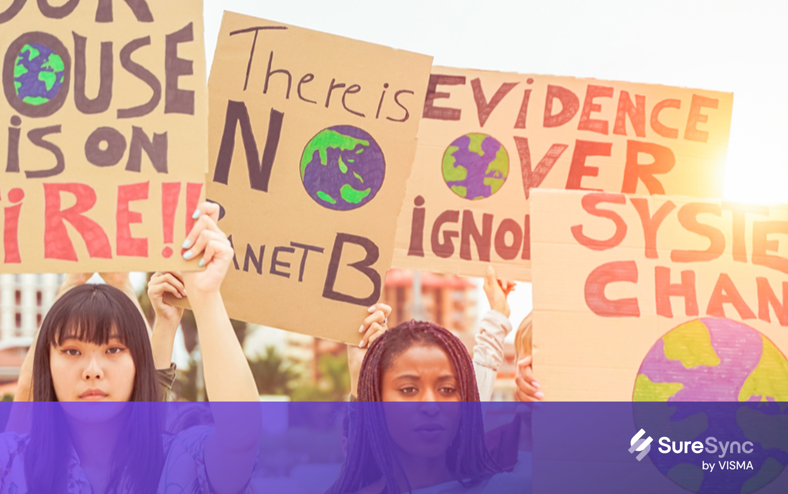 Two female participants of a climate rally holding up placcards